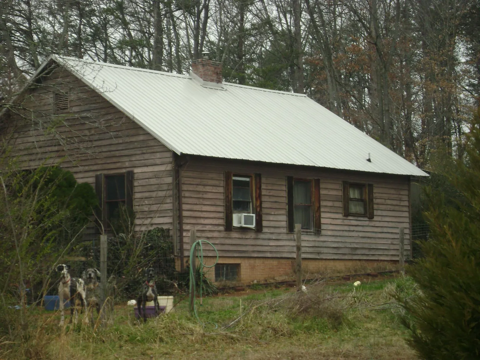 White metal roof on an old wood sided farmhouse, from a Metal Roof Installation job in Knob Lick